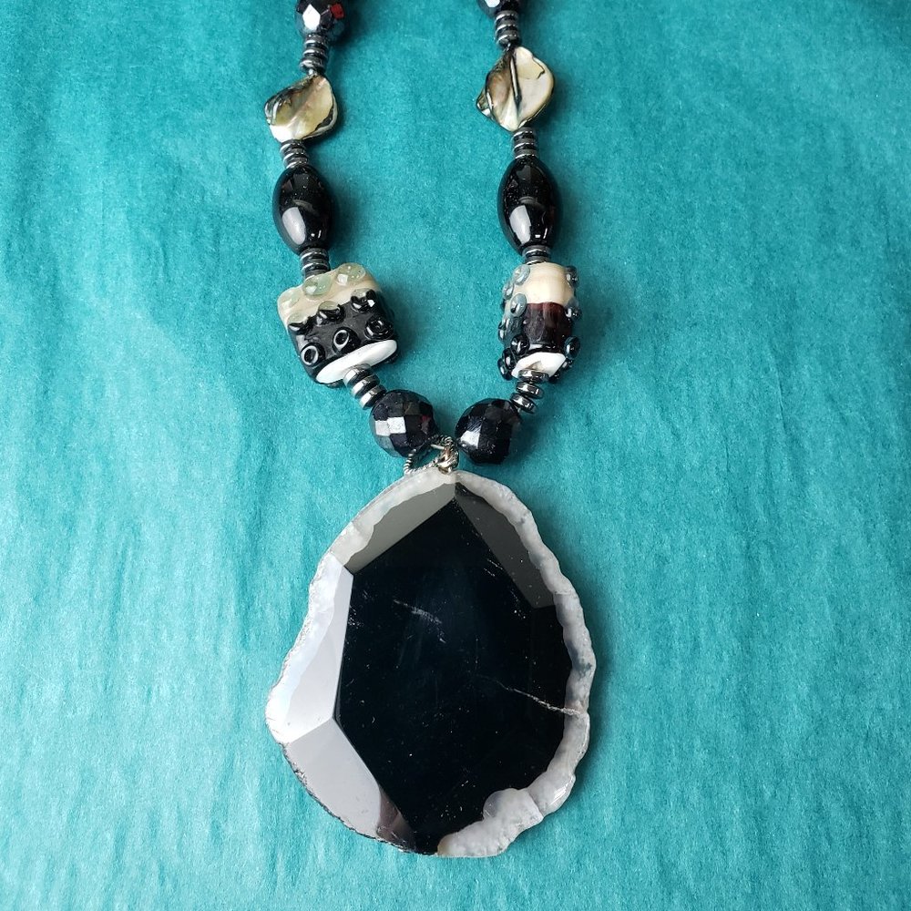 2/15$ Stones, glass and shell necklace